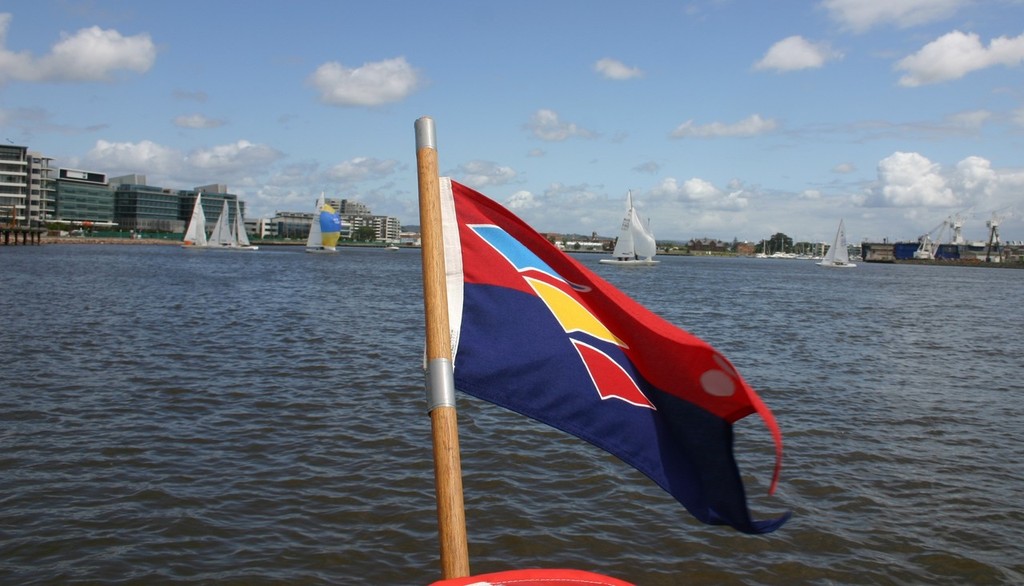 NCYC flag with Etchells racing in the background  - Newcastle Cruising Yacht Club’s (NCYC) Forgacs Etchells Offshore Regatta. © Paul Gleeson